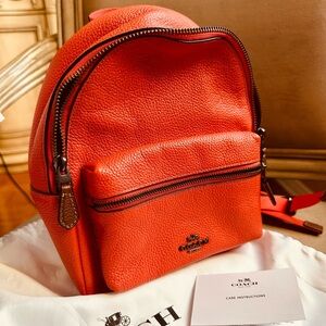 Coach x Keith Haring collaboration mini backpack in orange pebbled leather